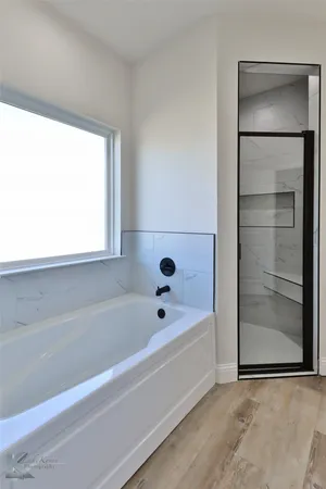 a bathroom with a bath tub and a sink