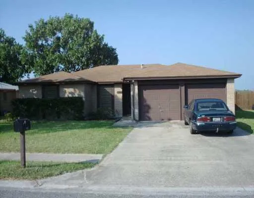 a car parked in front of white house