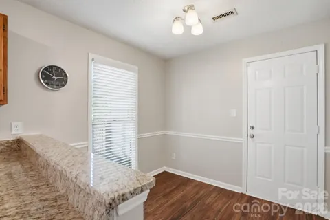 a view of hallway with wooden floor