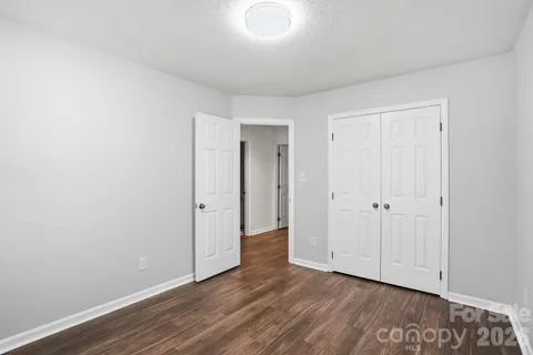 a view of an empty room and wooden floor