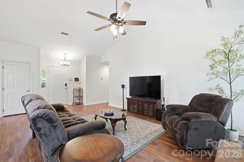 a living room with furniture a flat screen tv and a couch