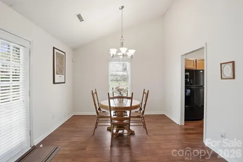 a dining room with furniture window and wooden floor