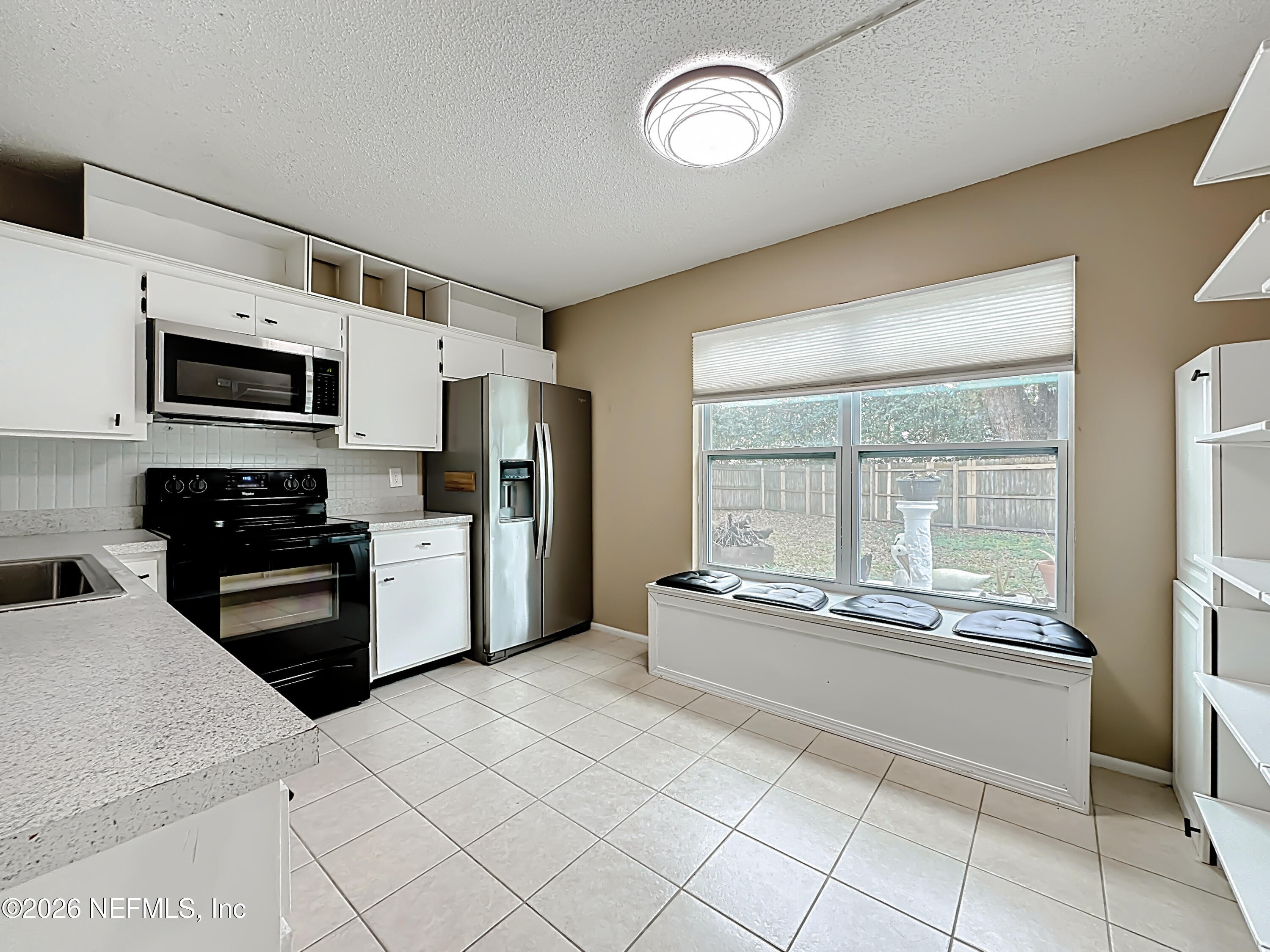 3410 Ricky Court Jacksonville, FL 32223 - Photo 11 of 37 a kitchen with granite countertop a refrigerator and a stove top oven
