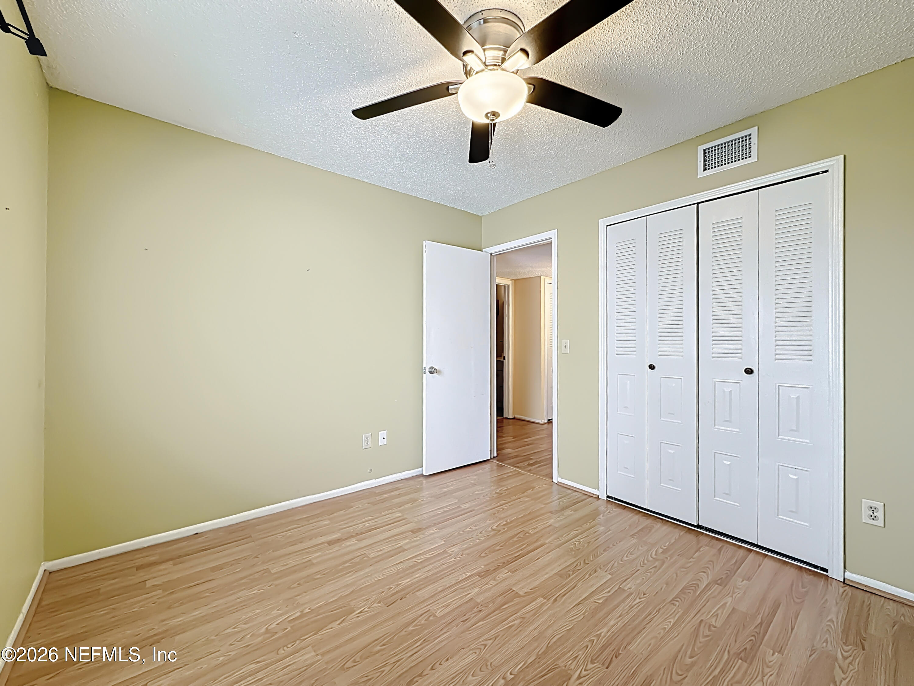 3410 Ricky Court Jacksonville, FL 32223 - Photo 17 of 37 an empty room with wooden floor a ceiling fan and closet