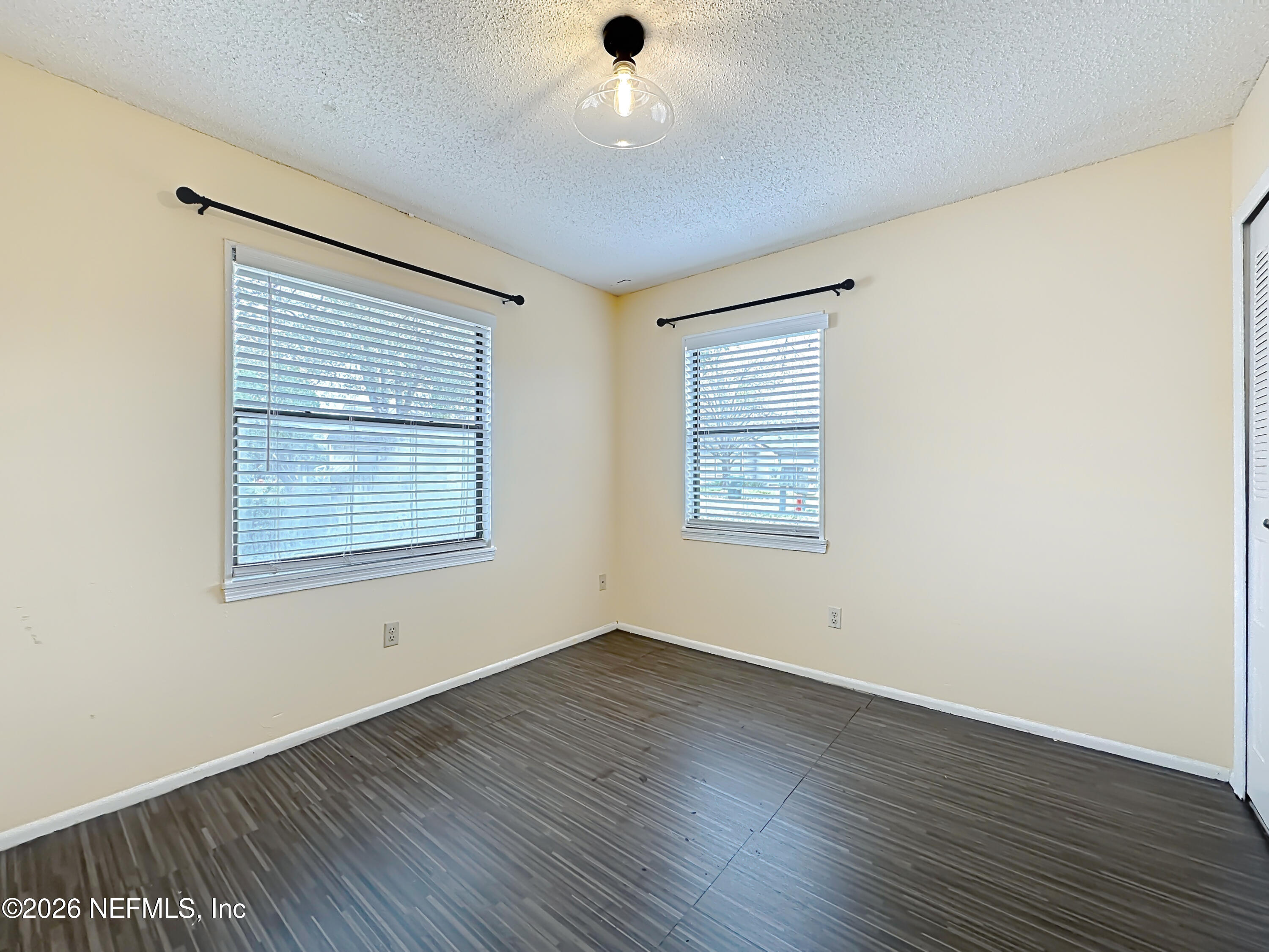 3410 Ricky Court Jacksonville, FL 32223 - Photo 18 of 37 an empty room with wooden floor and windows