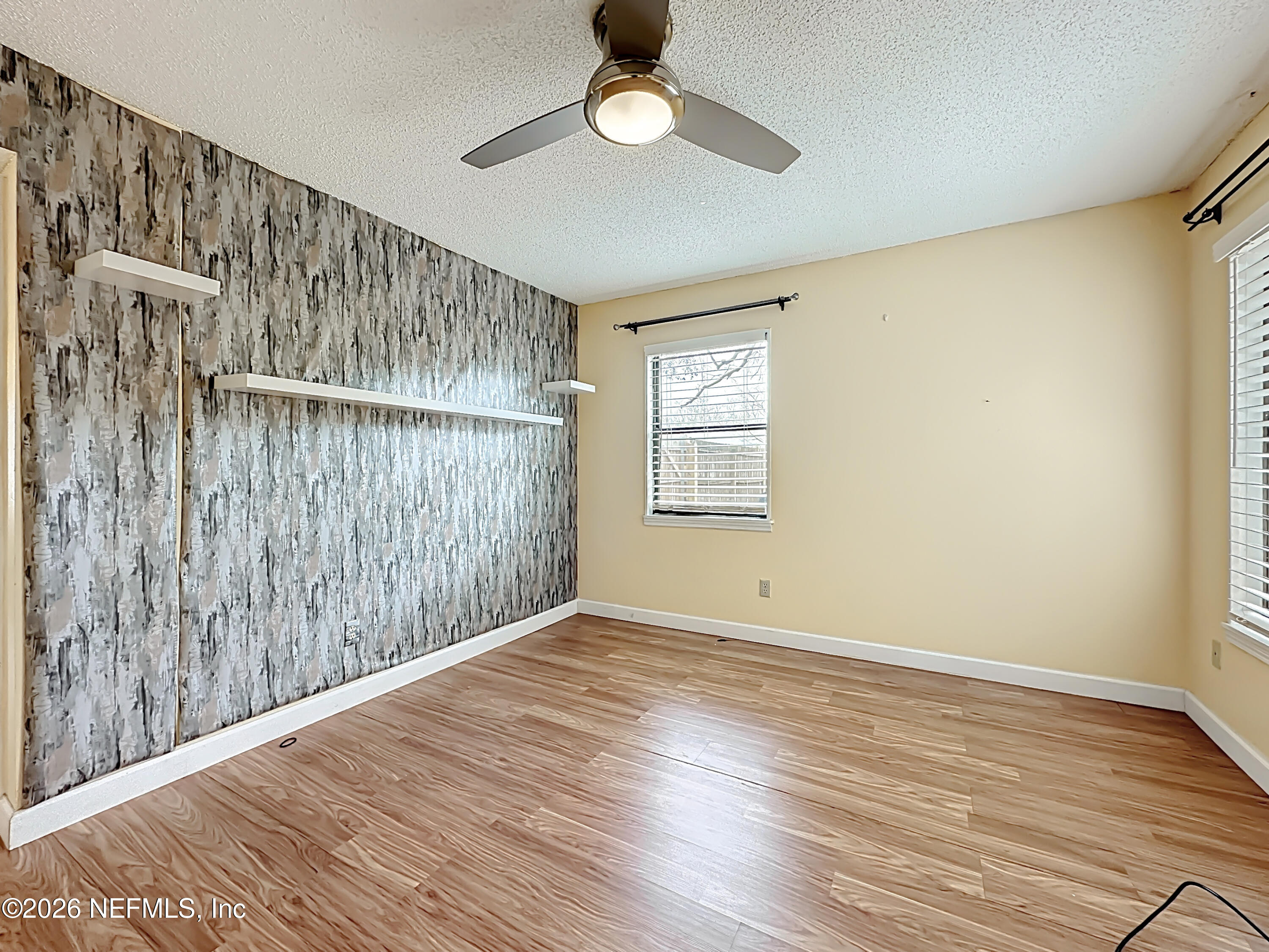 3410 Ricky Court Jacksonville, FL 32223 - Photo 23 of 37 a view of an empty room with wooden floor and a window