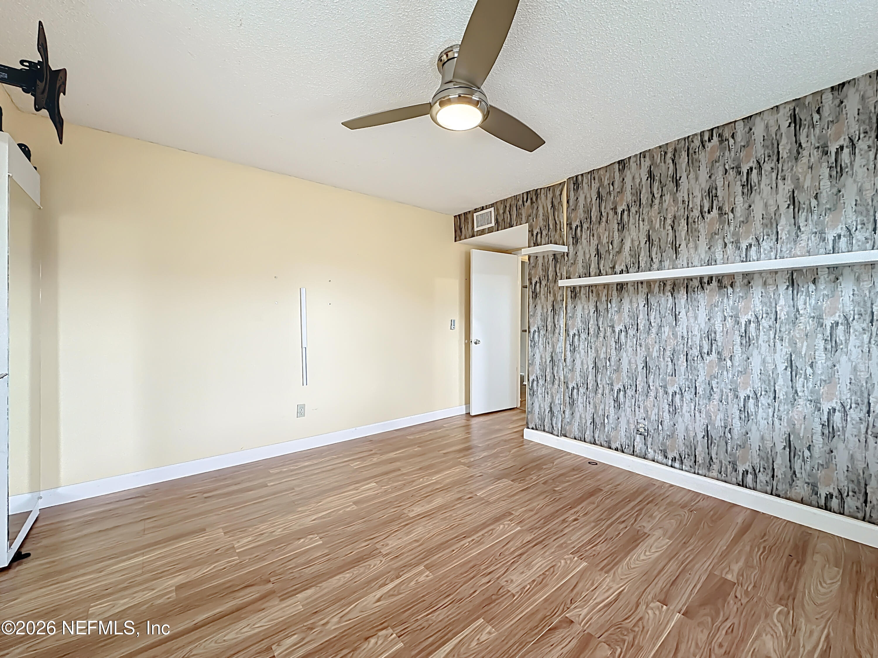 3410 Ricky Court Jacksonville, FL 32223 - Photo 24 of 37 a view of an empty room with wooden floor