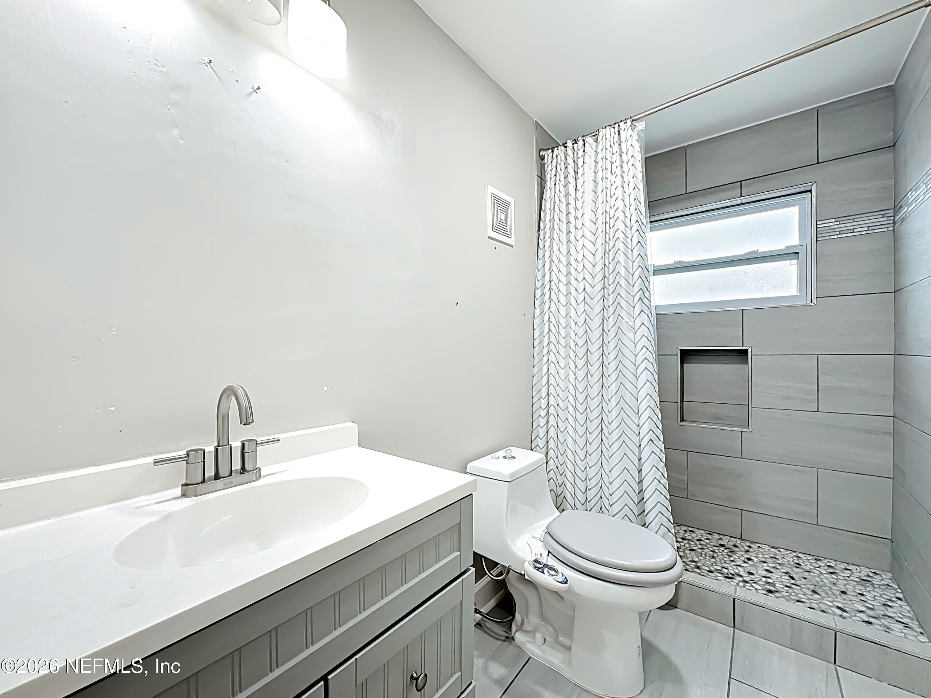 3410 Ricky Court Jacksonville, FL 32223 - Photo 26 of 37 a bathroom with a sink a toilet and shower