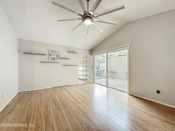 an empty room with wooden floor a ceiling fan and closet