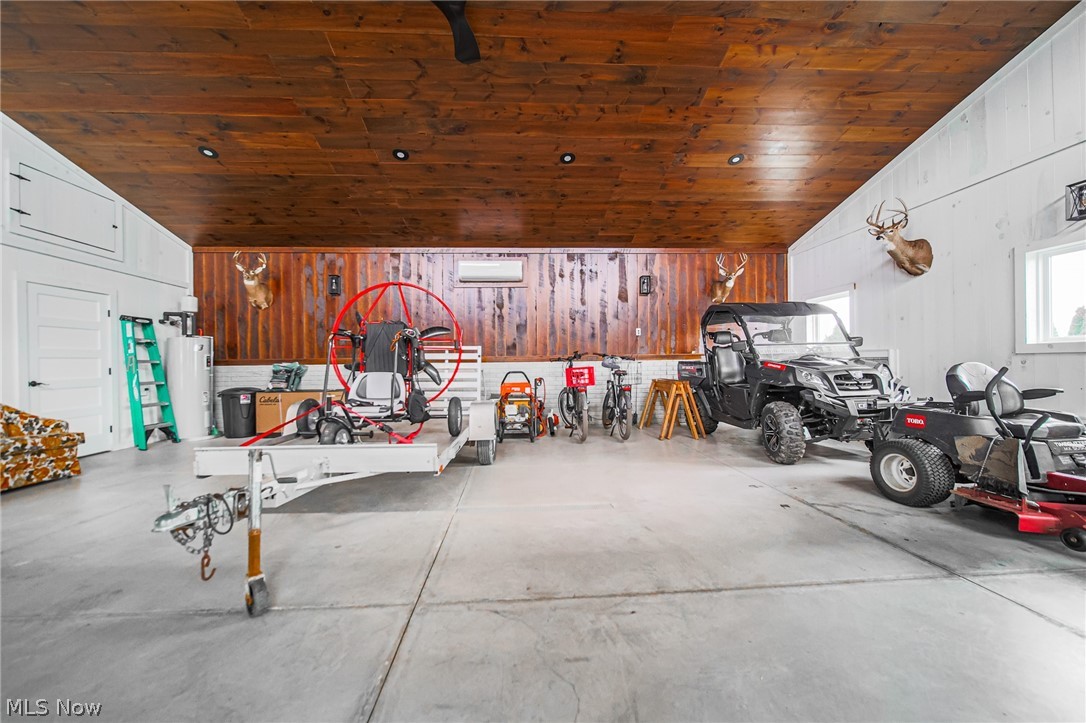 9554 Dover Road Apple Creek, OH 44606 - Photo 38 of 45 Garage featuring wooden walls, wooden ceiling, and water heater