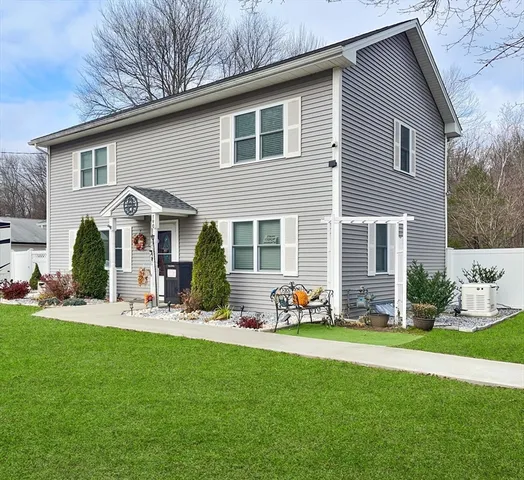 a front view of a house with garden and porch