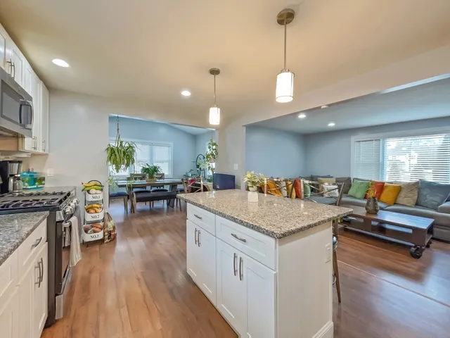 a room with furniture and kitchen view