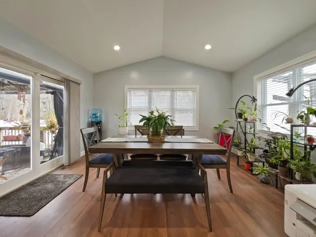 a view of a dining room with furniture window and wooden floor