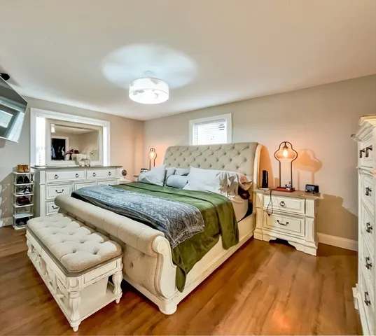 a bedroom with a bed and a flat screen tv