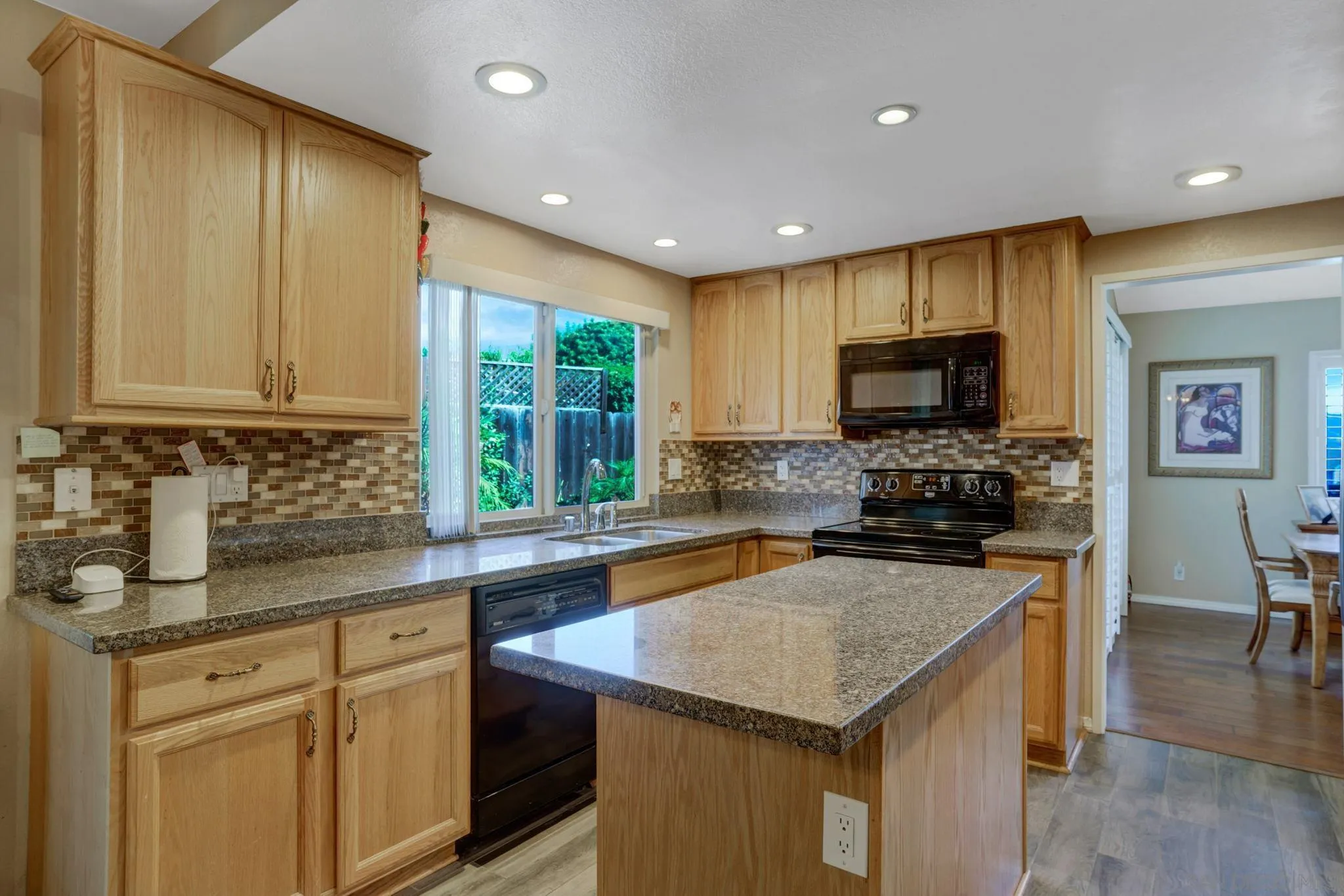 3006 Gayla Court Spring Valley, CA 91978 - Photo 15 of 39 a kitchen with a sink a counter top space cabinets and stainless steel appliances