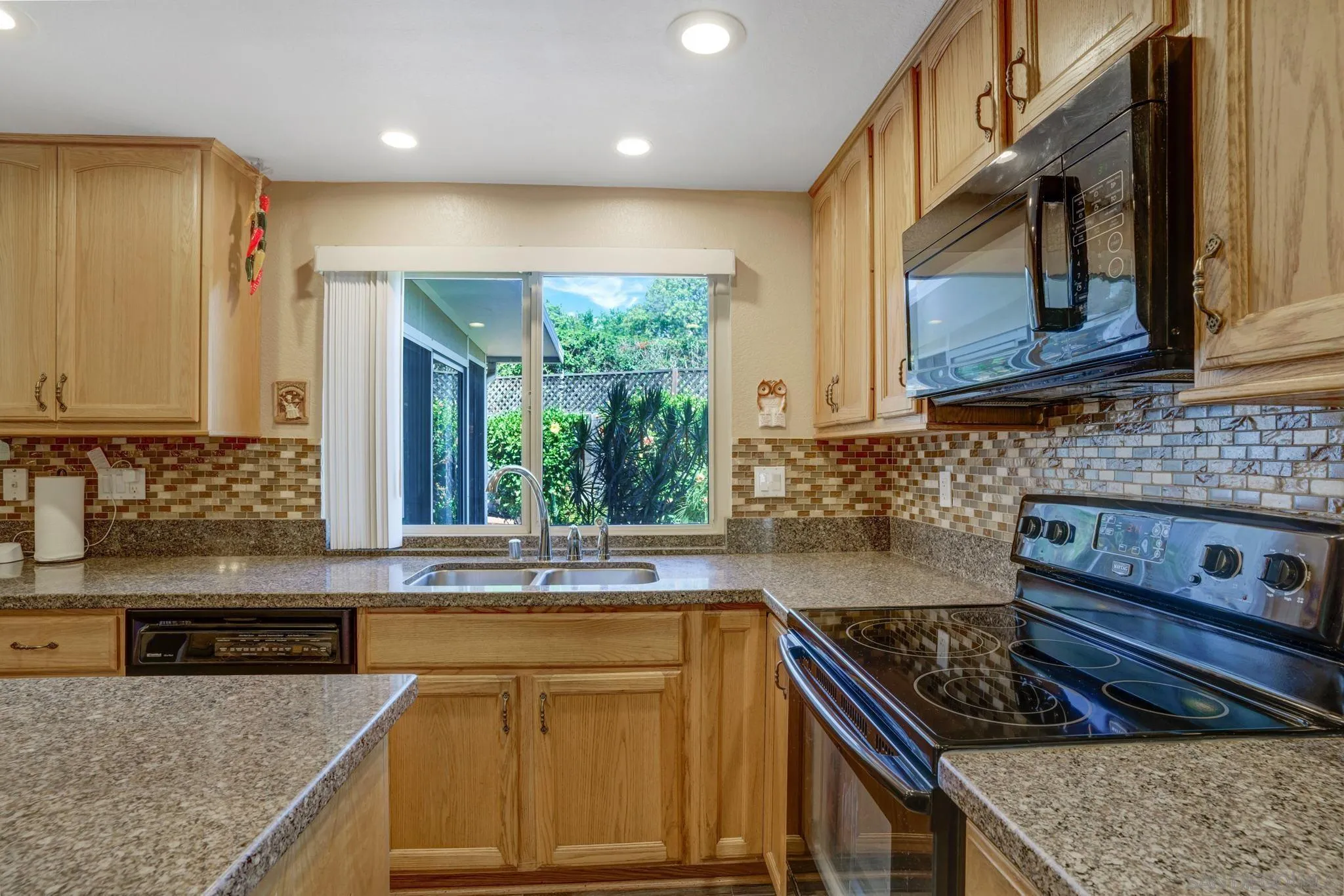 3006 Gayla Court Spring Valley, CA 91978 - Photo 16 of 39 a kitchen with stainless steel appliances granite countertop a sink stove and cabinets
