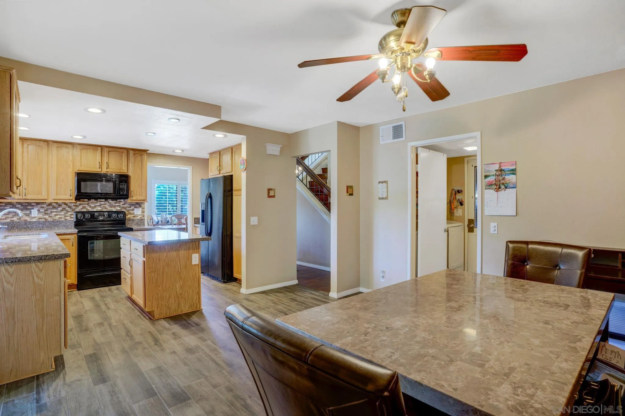 3006 Gayla Court Spring Valley, CA 91978 - Photo 17 of 39 a kitchen with a refrigerator a stove top oven a sink dishwasher and wooden floor