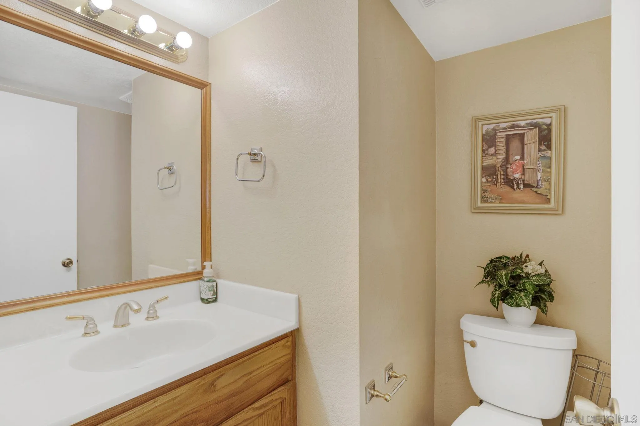 3006 Gayla Court Spring Valley, CA 91978 - Photo 20 of 39 a bathroom with a toilet sink and mirror