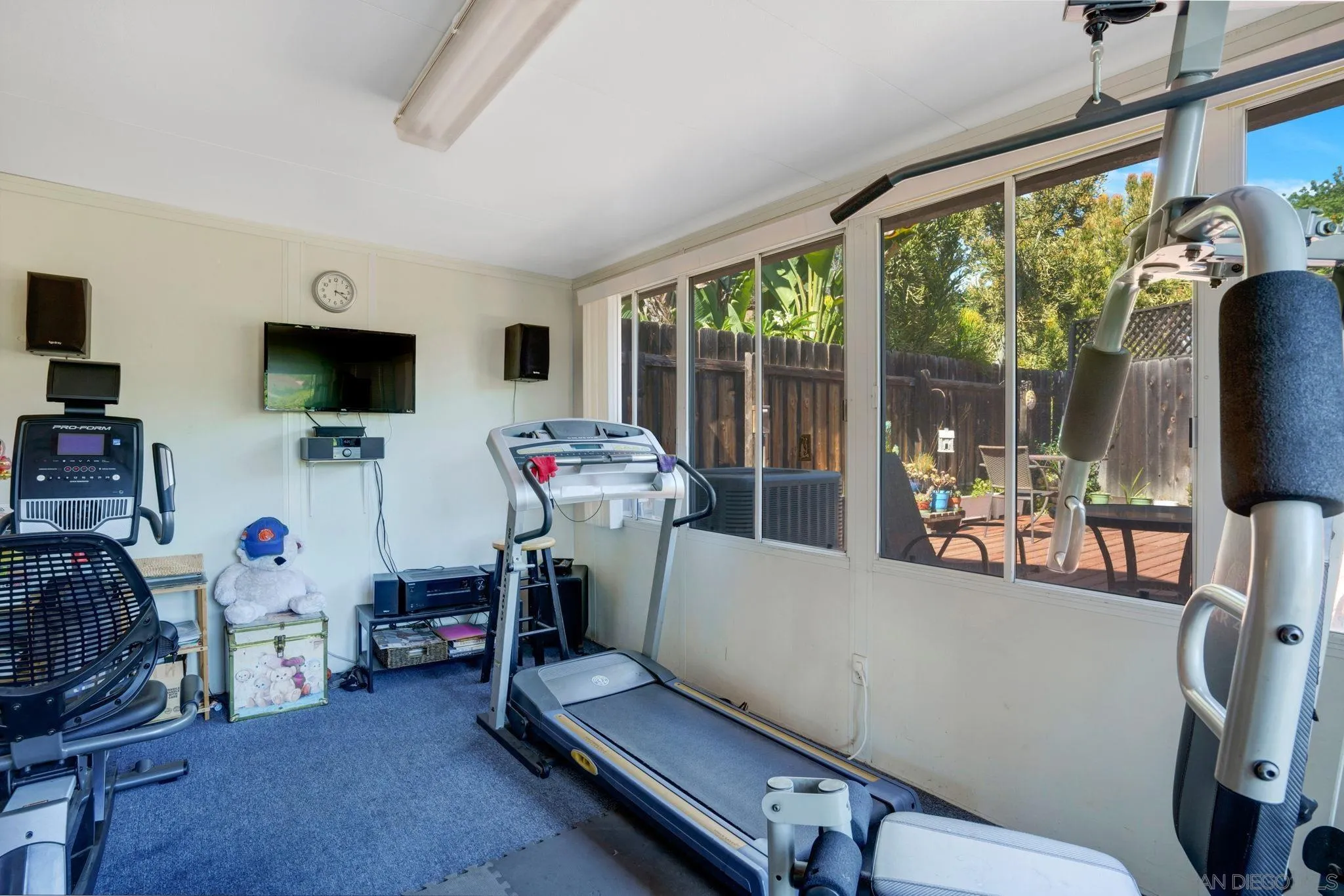 3006 Gayla Court Spring Valley, CA 91978 - Photo 27 of 39 a living room with furniture a flat screen tv and a floor to ceiling window