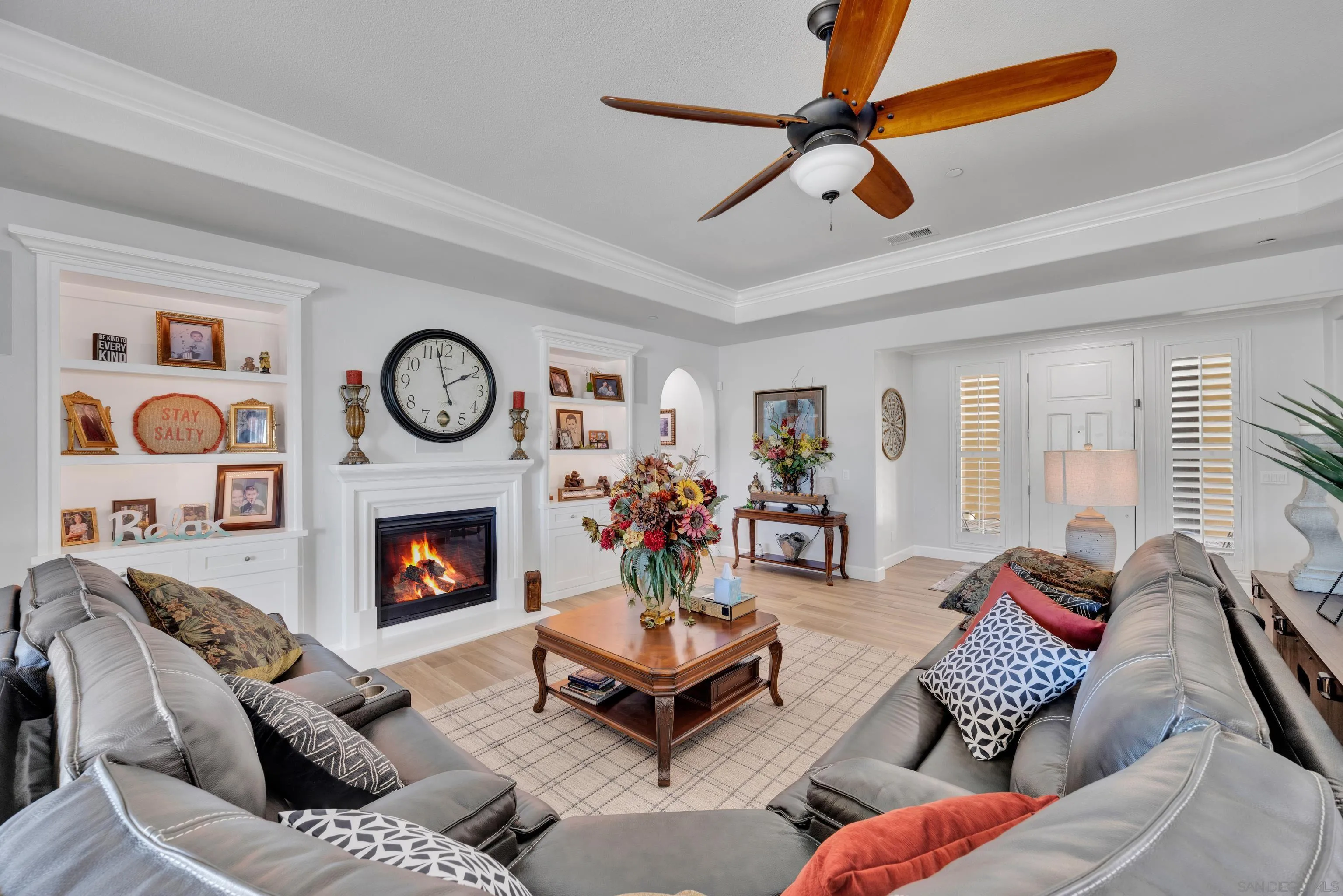 5620 Rancho Del Caballo Bonsall, CA 92003 - Photo 13 of 62 a living room with furniture a clock and a fireplace