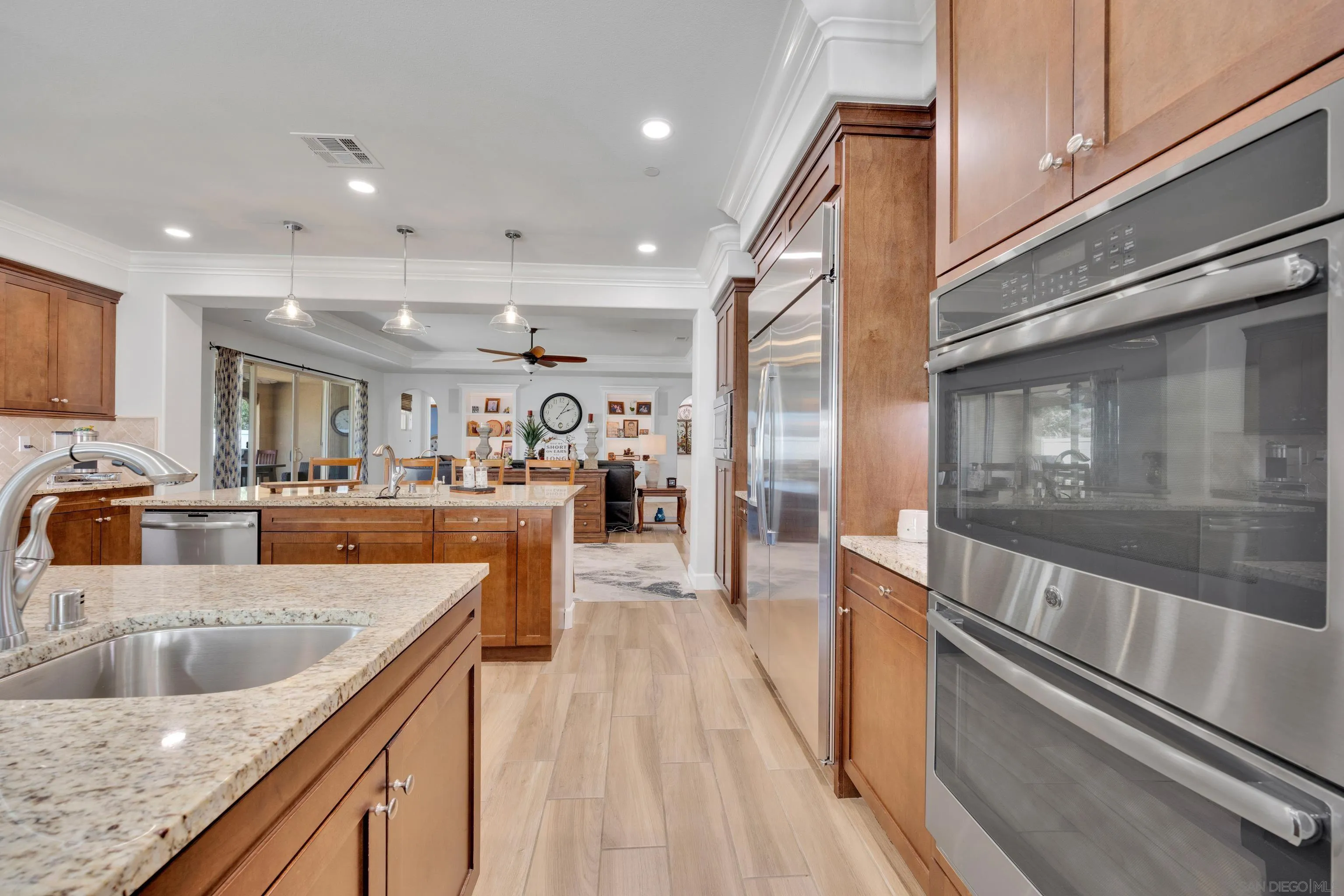 5620 Rancho Del Caballo Bonsall, CA 92003 - Photo 20 of 62 a large kitchen with stainless steel appliances granite countertop a lot of counter space and wooden floors
