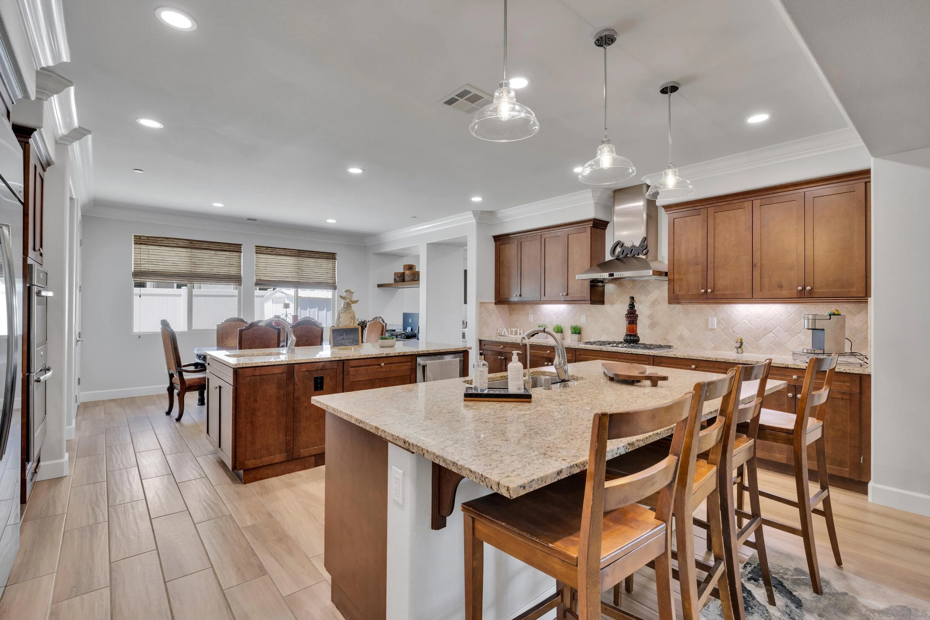 5620 Rancho Del Caballo Bonsall, CA 92003 - Photo 3 of 62 a kitchen with stainless steel appliances granite countertop a table chairs sink refrigerator and cabinets