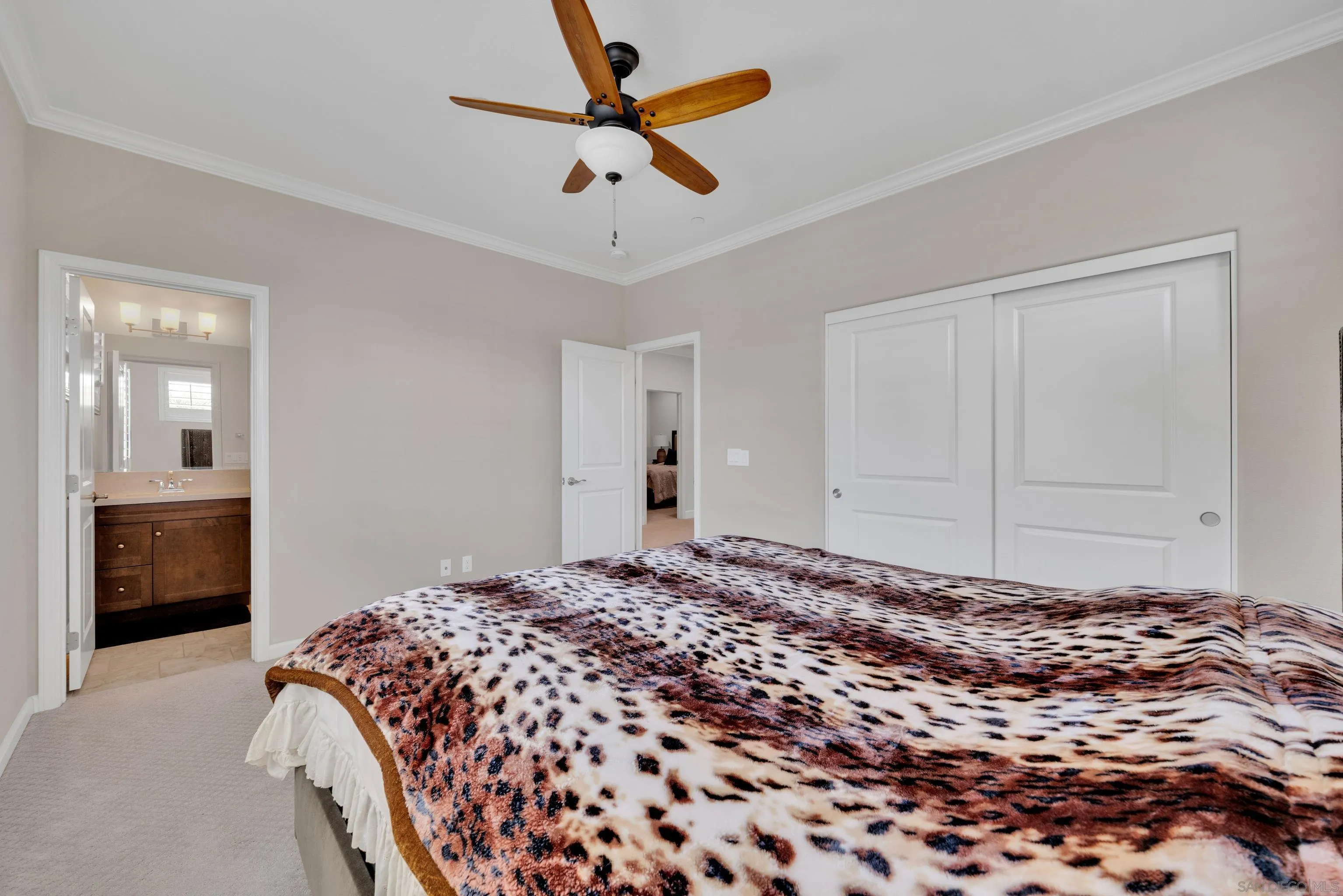5620 Rancho Del Caballo Bonsall, CA 92003 - Photo 46 of 62 a bedroom with a large bed and a chandelier fan