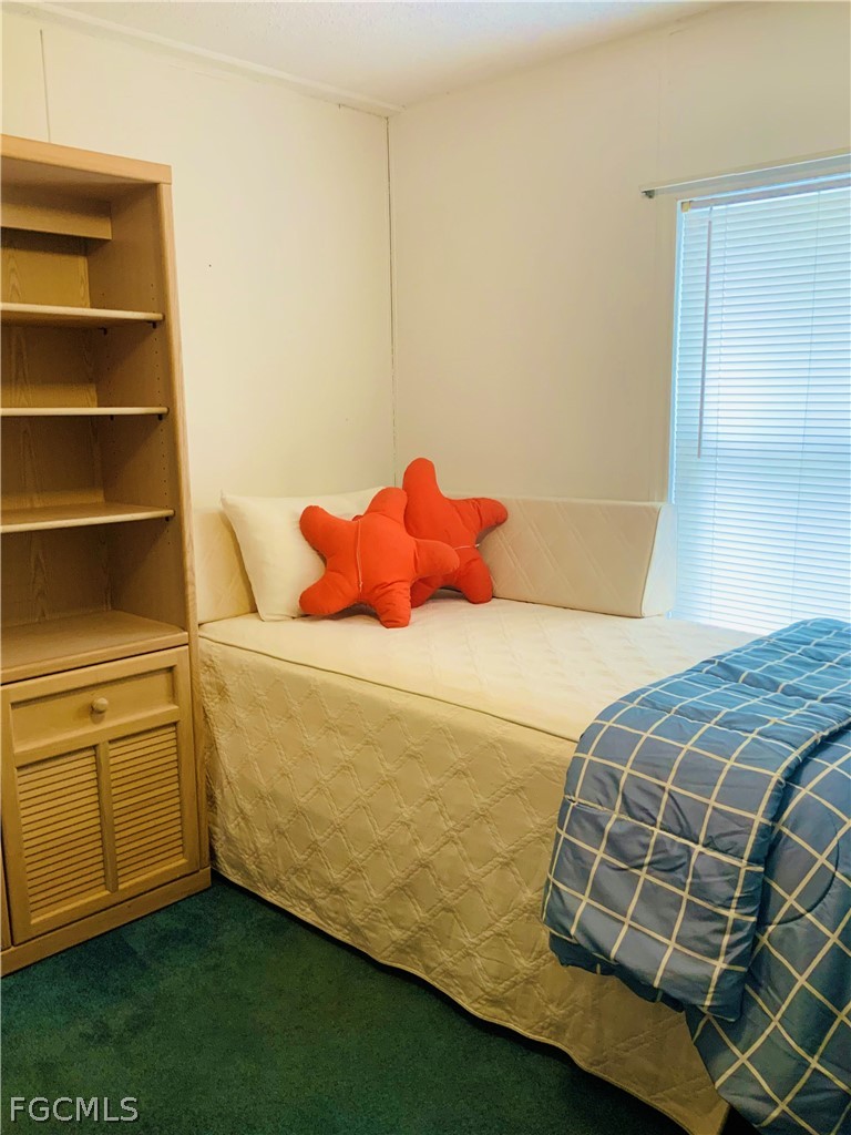 15550 Burnt Store Road, Unit 89 Punta Gorda, FL 33955 - Photo 12 of 28 a bedroom with a bed and a window