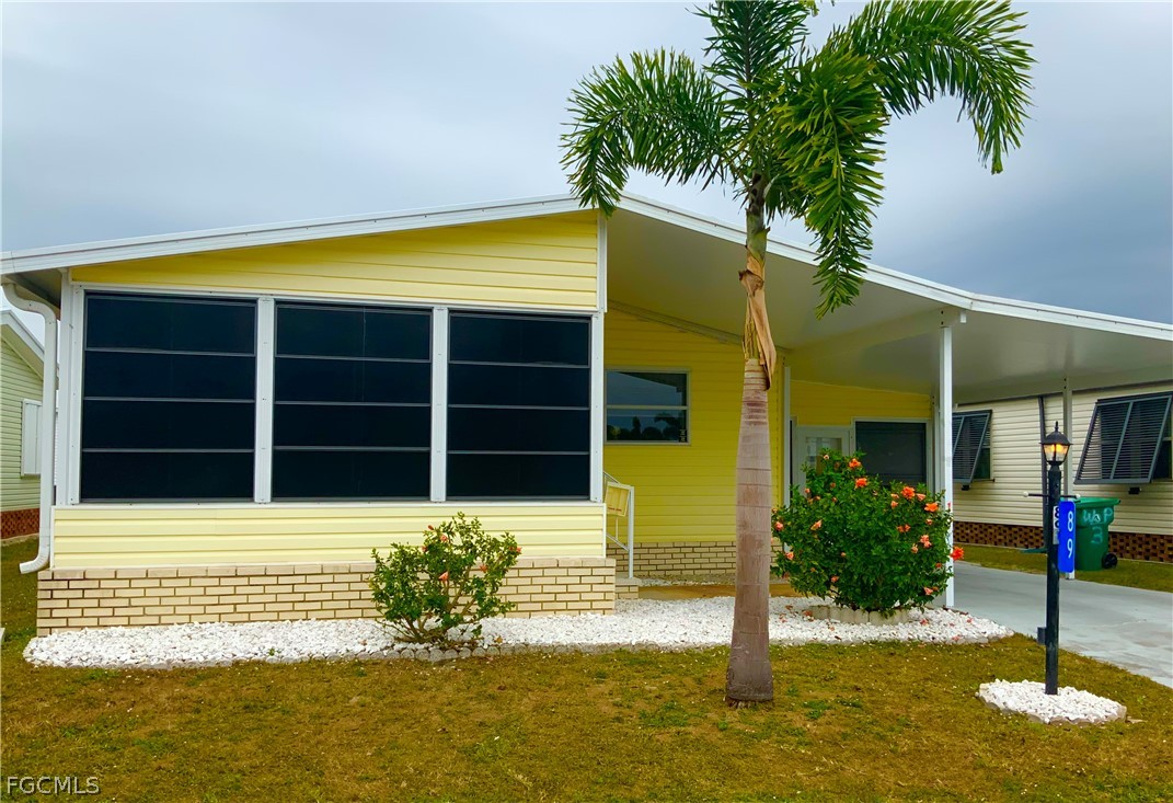 15550 Burnt Store Road, Unit 89 Punta Gorda, FL 33955 - Photo 2 of 28 a view of a house with a swimming pool