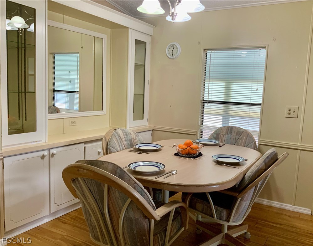 15550 Burnt Store Road, Unit 89 Punta Gorda, FL 33955 - Photo 3 of 28 a view of a dining room with furniture and wooden floor