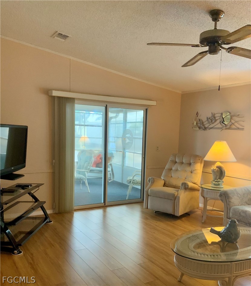 15550 Burnt Store Road, Unit 89 Punta Gorda, FL 33955 - Photo 8 of 28 a living room with furniture and a flat screen tv