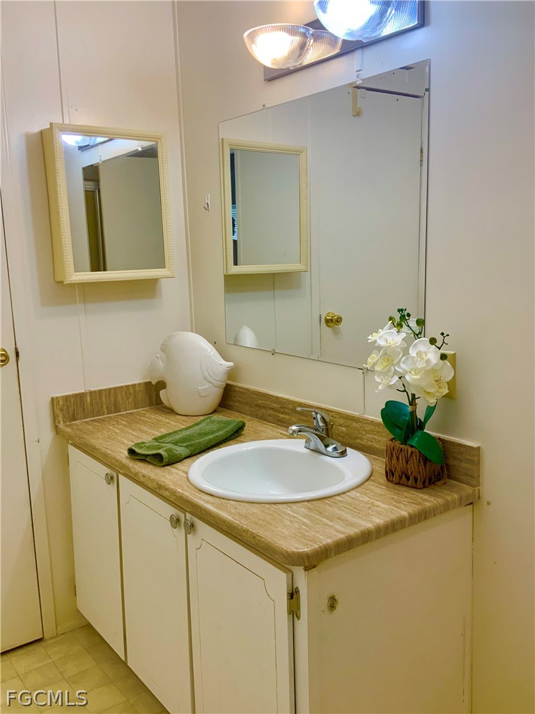 15550 Burnt Store Road, Unit 89 Punta Gorda, FL 33955 - Photo 10 of 28 a bathroom with a sink and a mirror