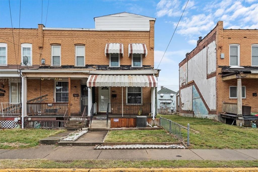 1140 Race Street McKees Rocks, PA 15136 - Photo 1 of 25 a front view of a house with a yard