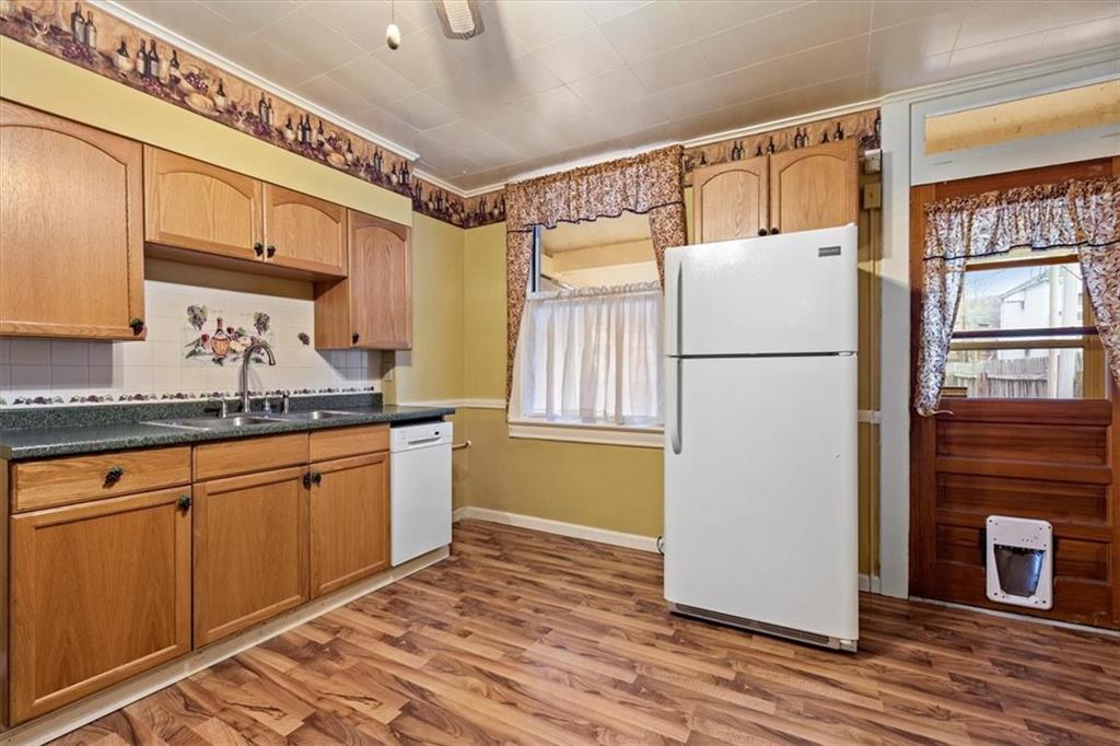 1140 Race Street McKees Rocks, PA 15136 - Photo 11 of 25 a kitchen with refrigerator a sink and cabinets