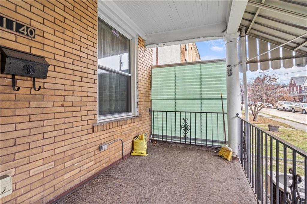 1140 Race Street McKees Rocks, PA 15136 - Photo 2 of 25 a view of a porch with wooden floor and fence