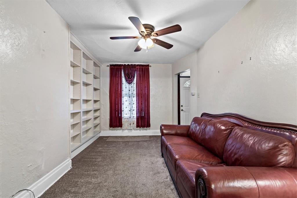 1140 Race Street McKees Rocks, PA 15136 - Photo 9 of 25 a living room with furniture and a ceiling fan