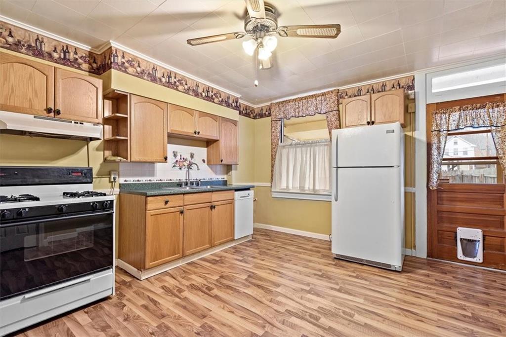 1140 Race Street McKees Rocks, PA 15136 - Photo 10 of 25 a kitchen with refrigerator cabinets and wooden floor