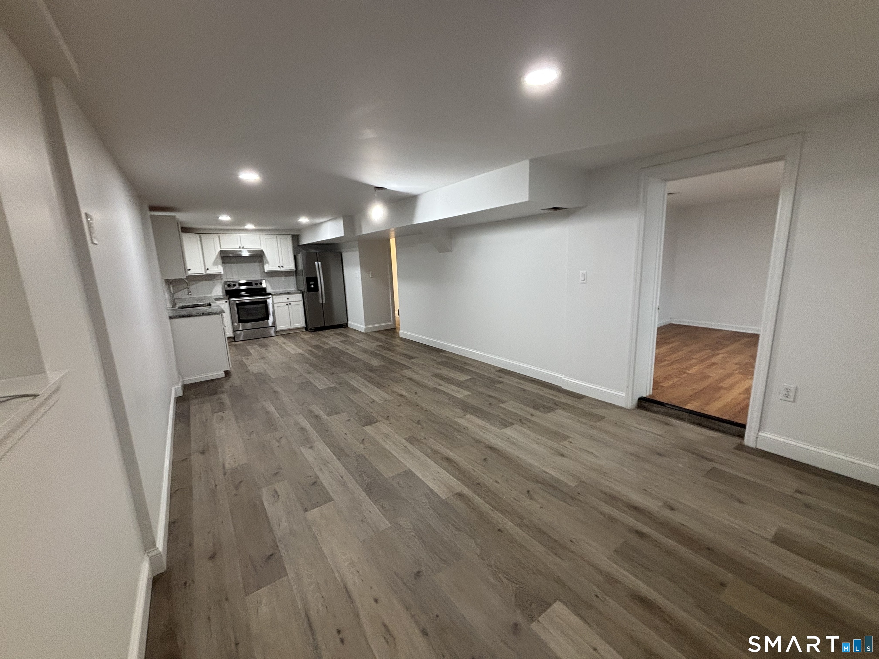 76 Cannon Street Hamden, CT 06518 - Photo 3 of 9 an empty room with wooden floor and a window