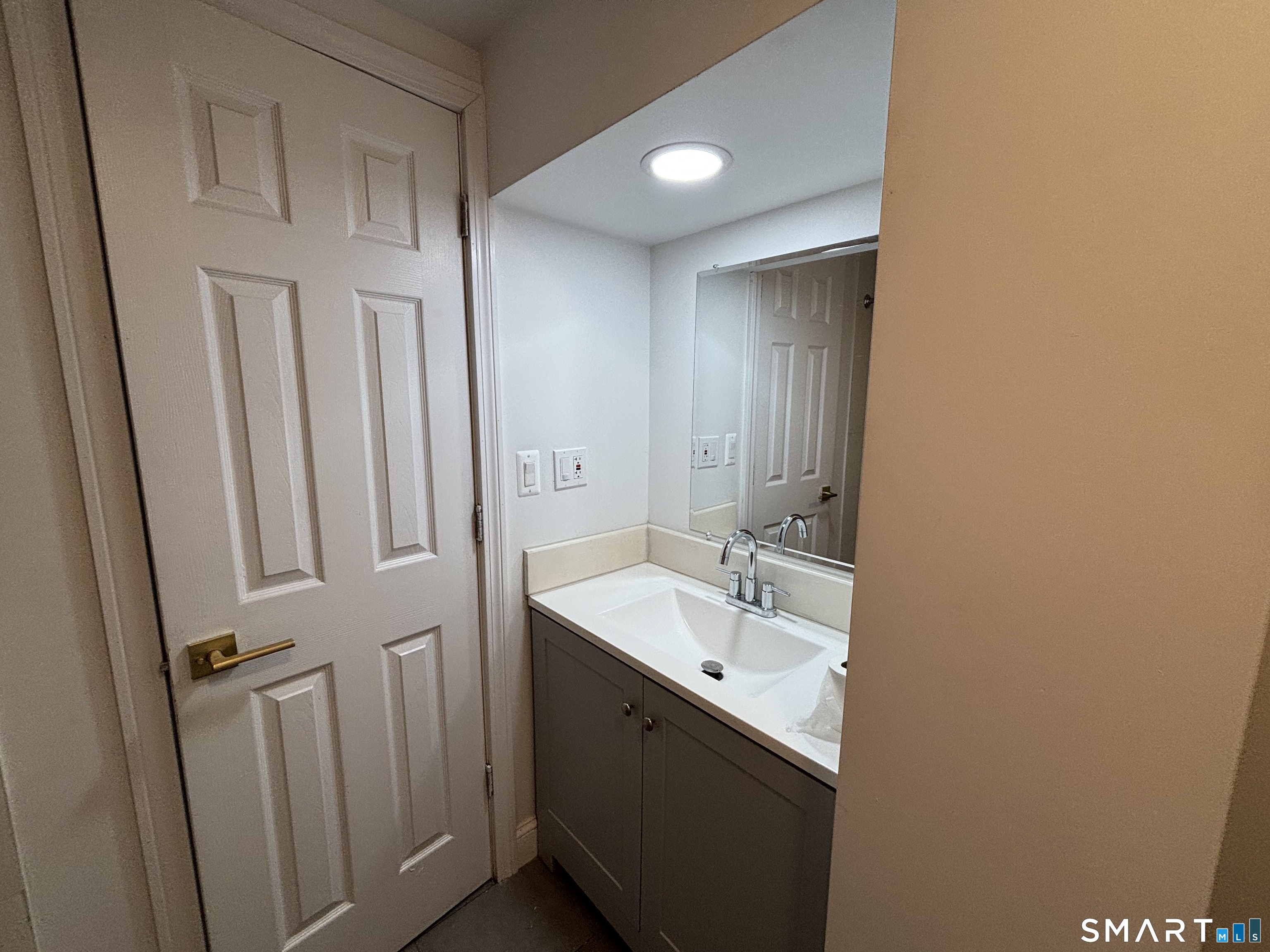 76 Cannon Street Hamden, CT 06518 - Photo 5 of 9 a bathroom with a sink and mirror with toilet