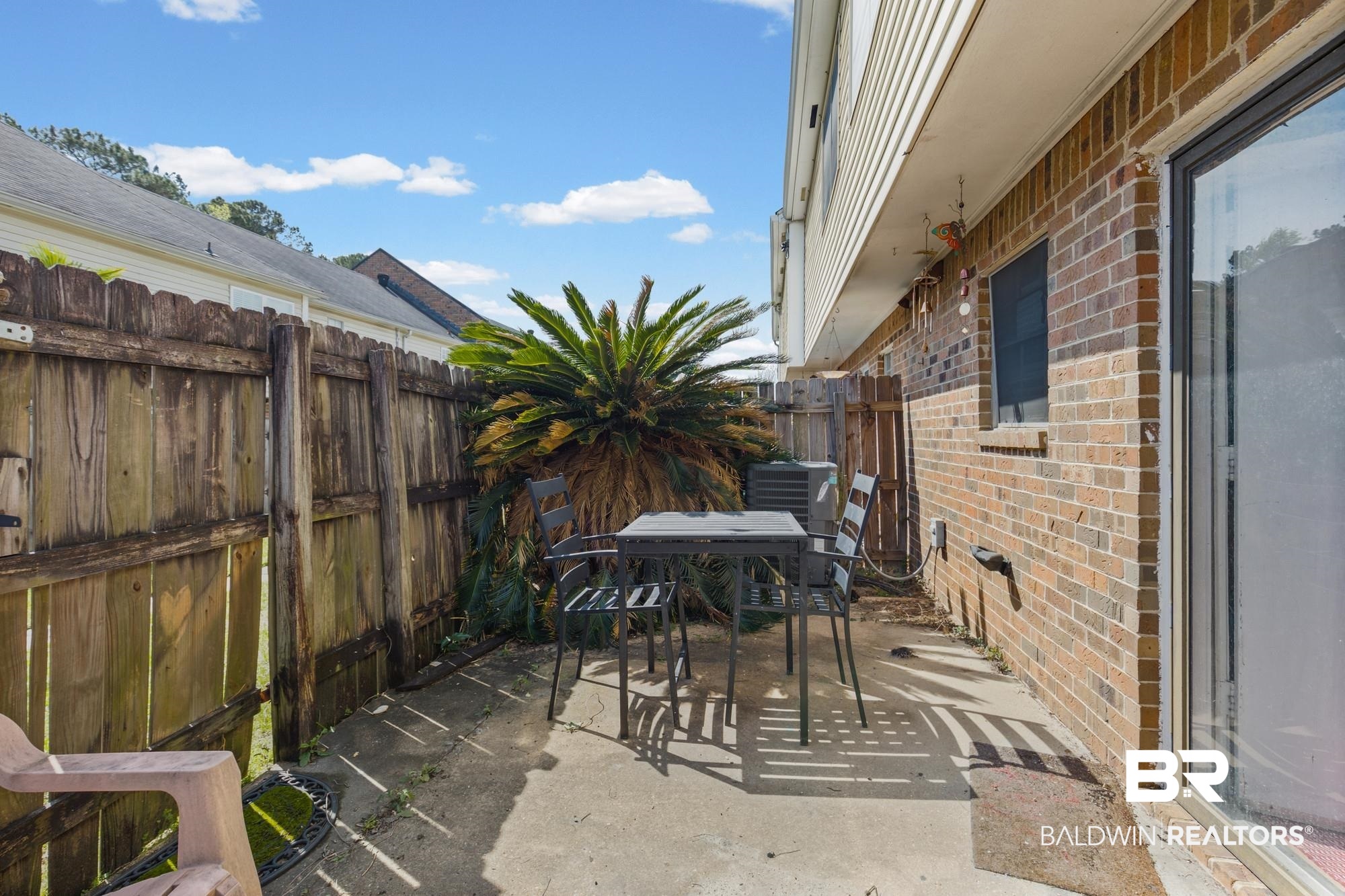 114 Du Rhu Drive, Unit A Mobile, AL 36608 - Photo 9 of 14 Fenced backyard featuring a patio area and outdoor dining space