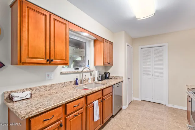 a kitchen with stainless steel appliances granite countertop a sink and a cabinets