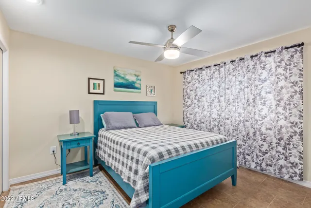 a bedroom with a bed and a chandelier