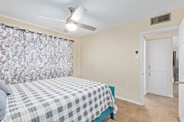 a bedroom with a bed and a chandelier