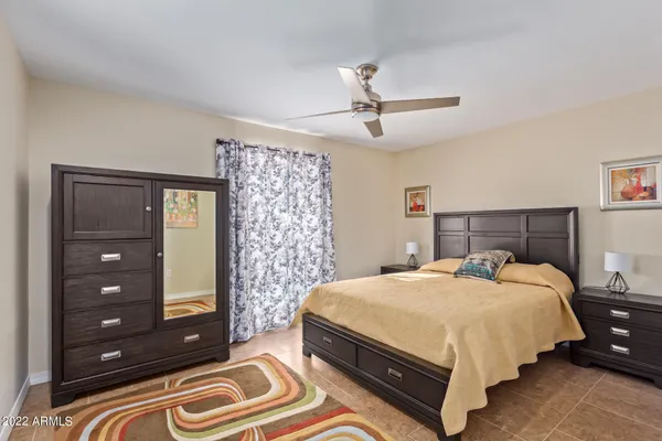 a bedroom with a bed and a dresser