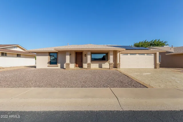 a front view of a house with garage