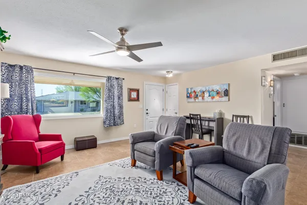 a living room with furniture a rug and a large window