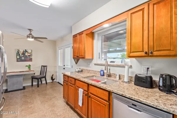 a kitchen with stainless steel appliances granite countertop sink stove and cabinets