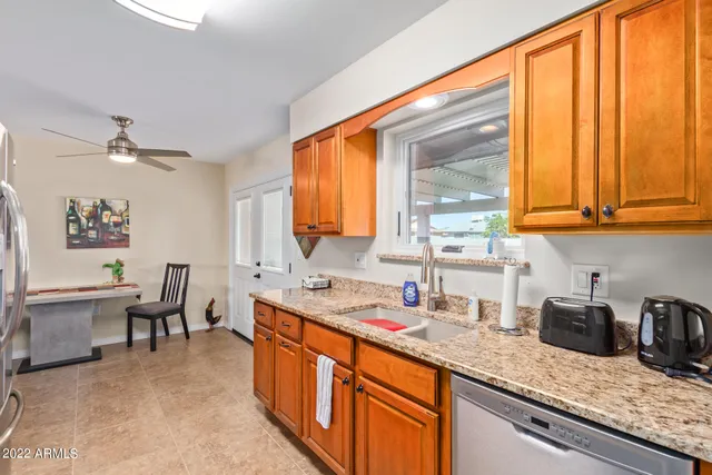 a kitchen with stainless steel appliances granite countertop sink stove and cabinets