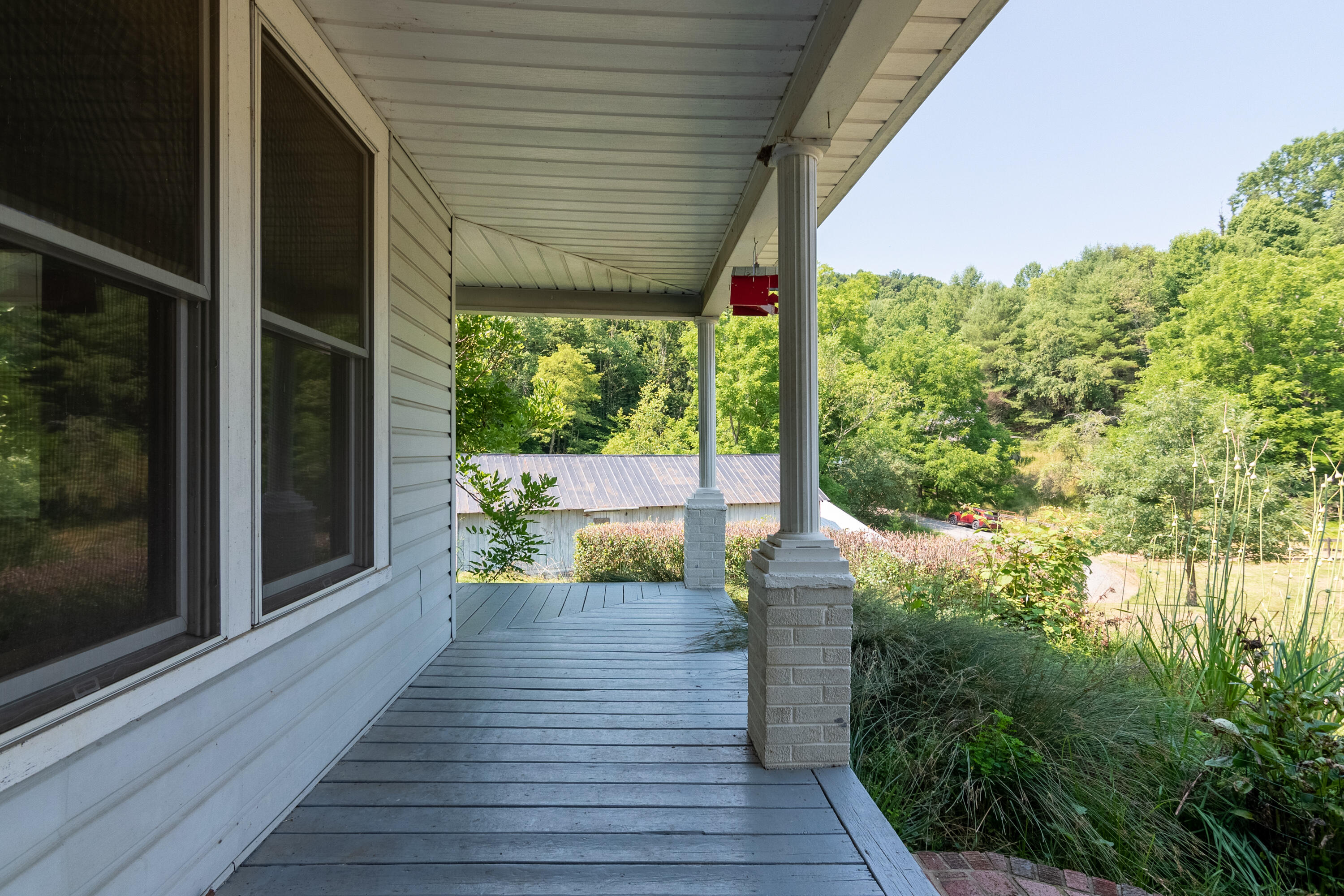 415 Reed Hill Road Northwest Floyd, VA 24091 - Photo 14 of 69 a porch with seating space and yard in back