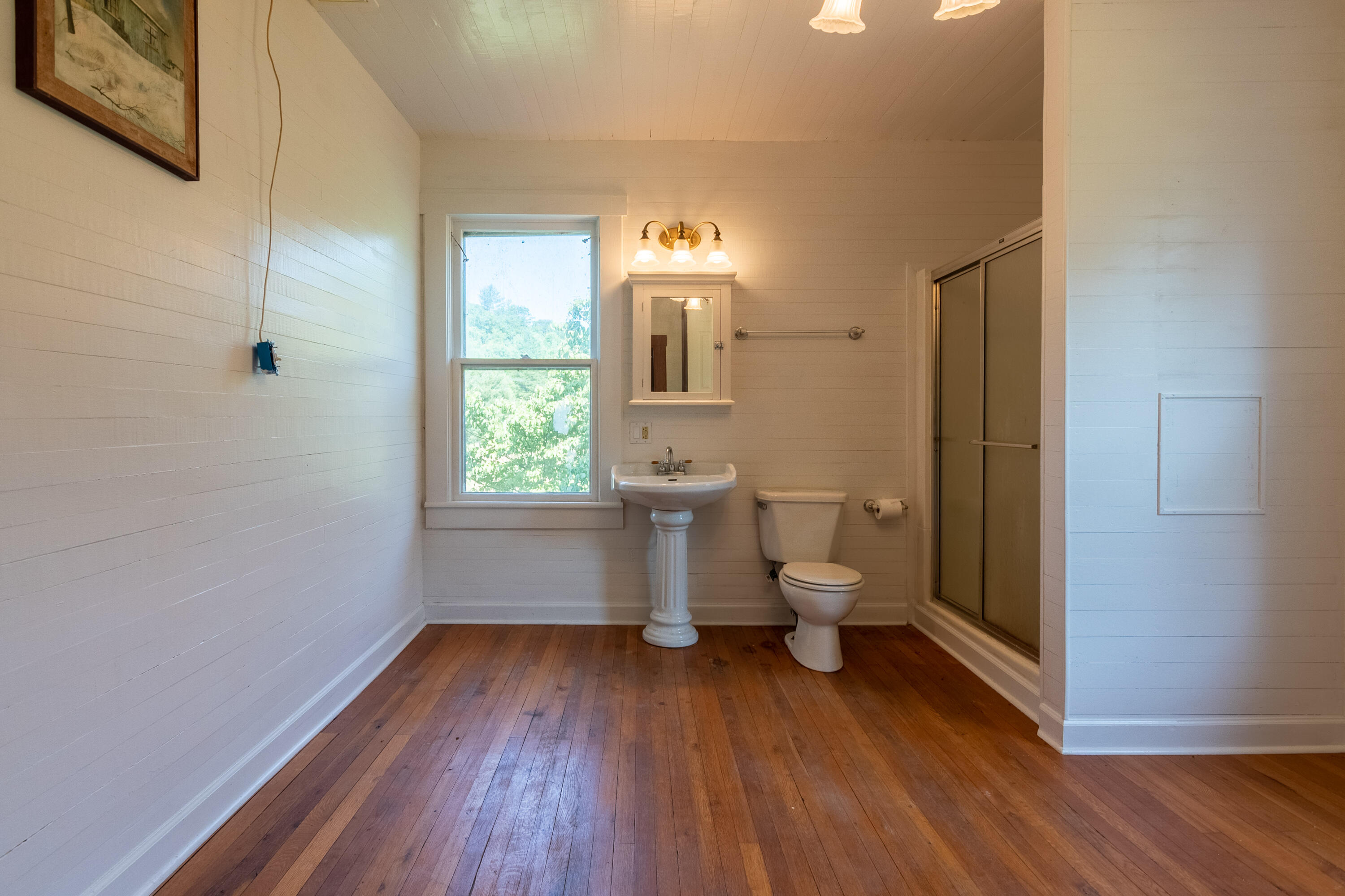 415 Reed Hill Road Northwest Floyd, VA 24091 - Photo 41 of 69 a bathroom with a toilet sink and a mirror